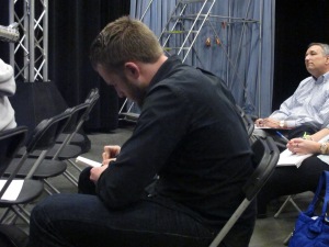 A student takes notes during the panel